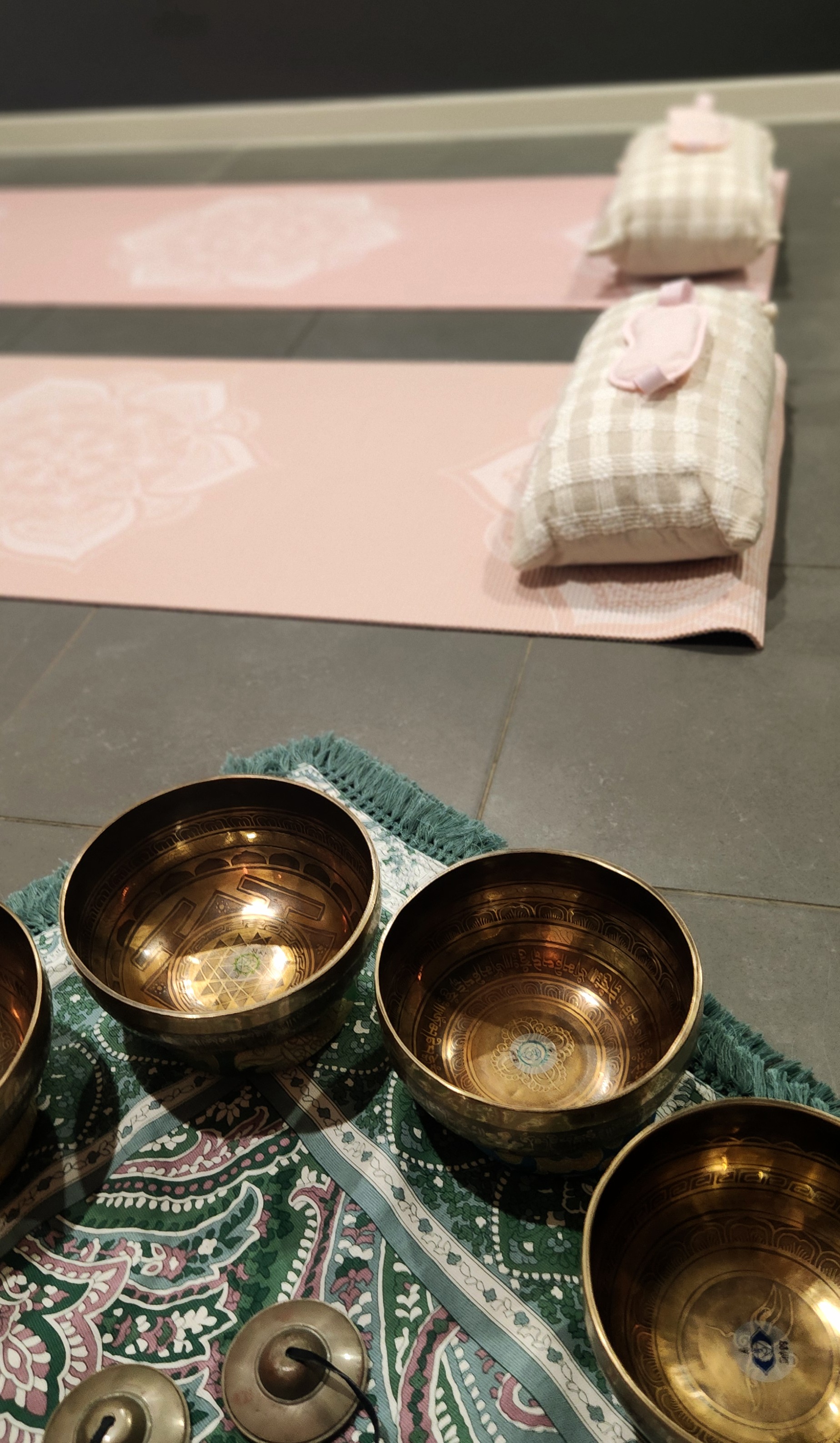 Sound healing session space set up with mats and singing bowls