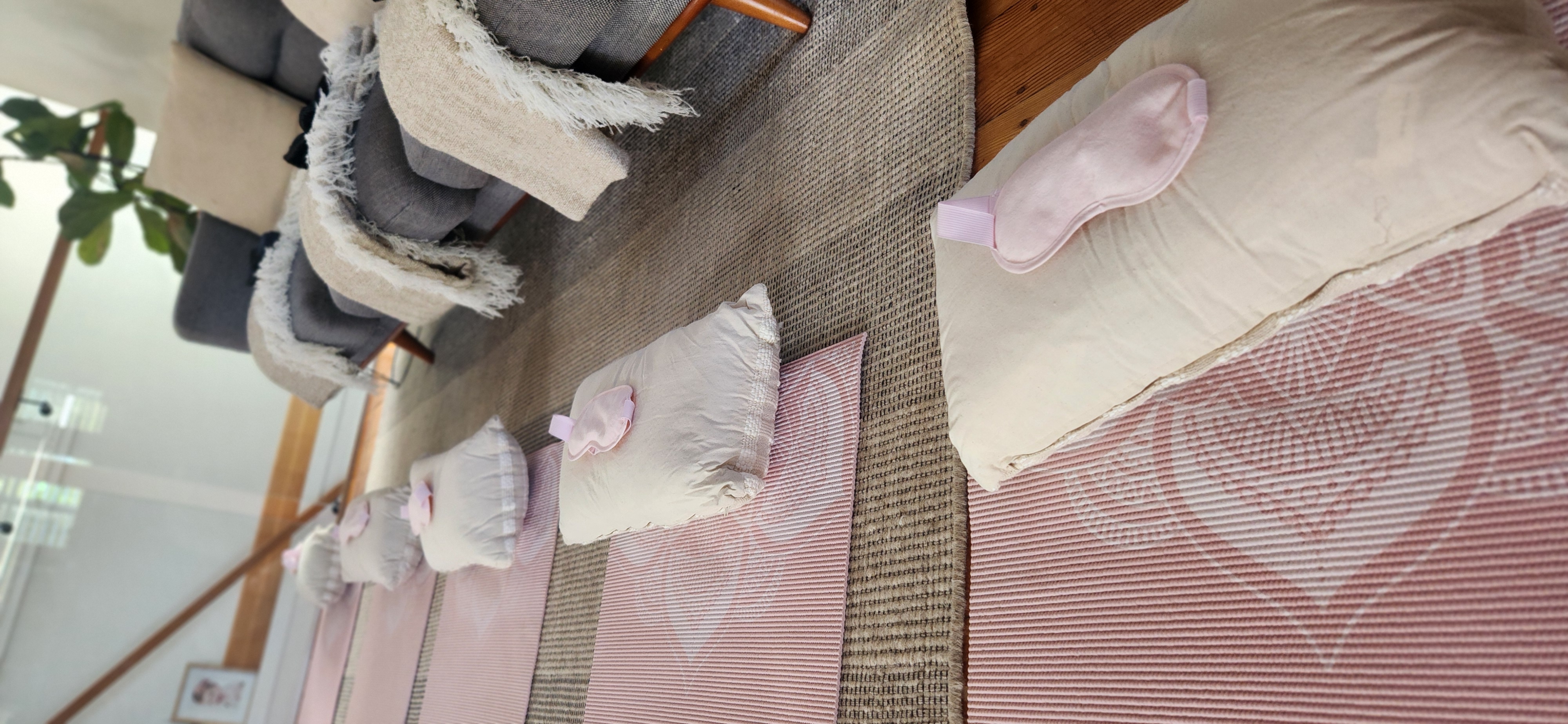 Sound healing space with mats, pillows and eye masks laid out