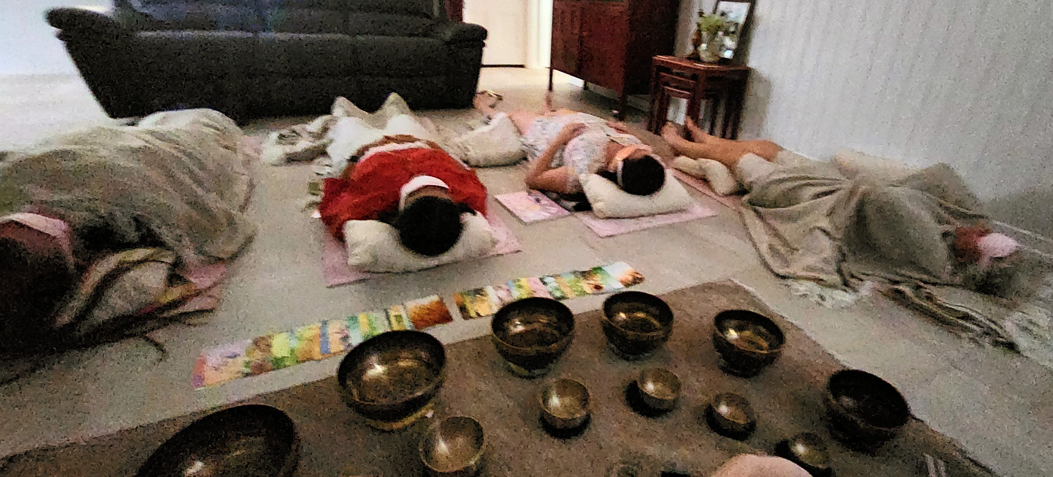 Group sound bath with participants resting on mats